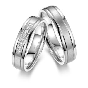 Elegant couple's matching rings, featuring intertwined silver bands, symbolizing love and unity, professionally photographed on a minimalist background.